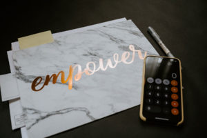 When Should You Bring In a Fractional CFO? "Empower" written on Jennifer Yousem's folder.